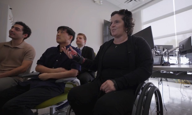 Cassie Mitchell talks with colleagues.
