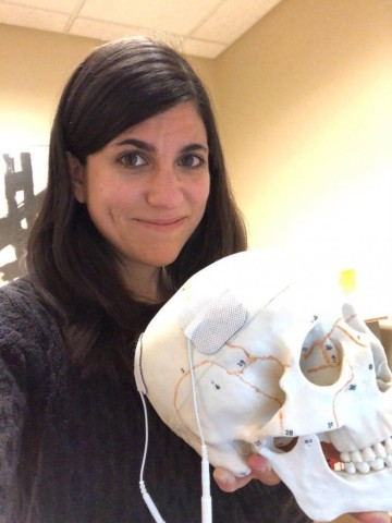 Students are often involved in Ragan's outreach efforts. Here, Ragan is holding a student-designed electroconvulsive-therapy model for a Brain Awareness Day event.