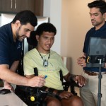 Kinemo co-founders Nordine Sebkhi and Arpan Bhavsar work with Wendell Odom during an assistive technology session using the Kinemo device to support independent computer and device control.