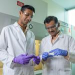 Dr. Krishnendu Roy (right) and Rachit Agarwal examine a silicon wafer. (Credit: Rob Felt)