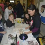 Christina Ragan challenging attendees with optical illusions at a previous Brain Awareness Day Neuroscience event held at Michigan State University.