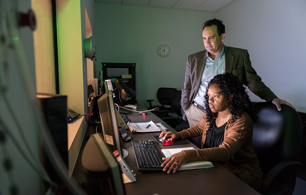 faculty and student looking at computer